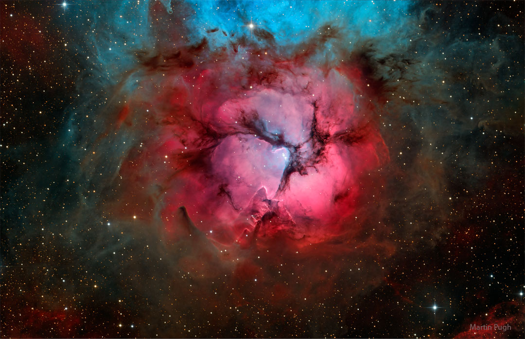 What's happening at the center of the Trifid Nebula?