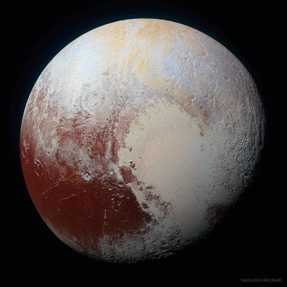 The large sphere is pictured with different color regions
on its surface. Irregularly shaped parts of tan, white, and brown.
Please see the explanation for more detailed information.