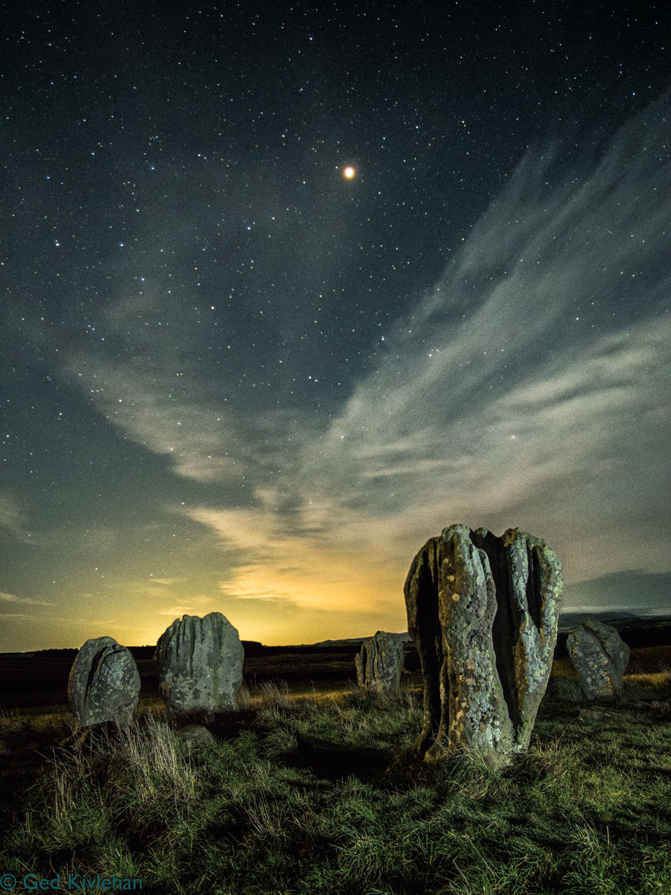 The planet Mars is pictured of the Duddo Stone Circle in the UK. See Explanation.