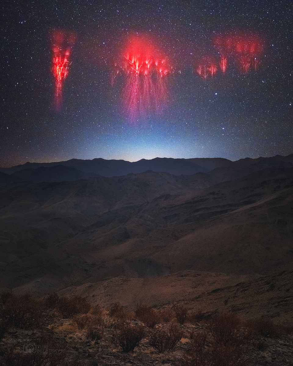 Several red sprite lightning plumes are pictured over the Andes Mountains. See Explanation.