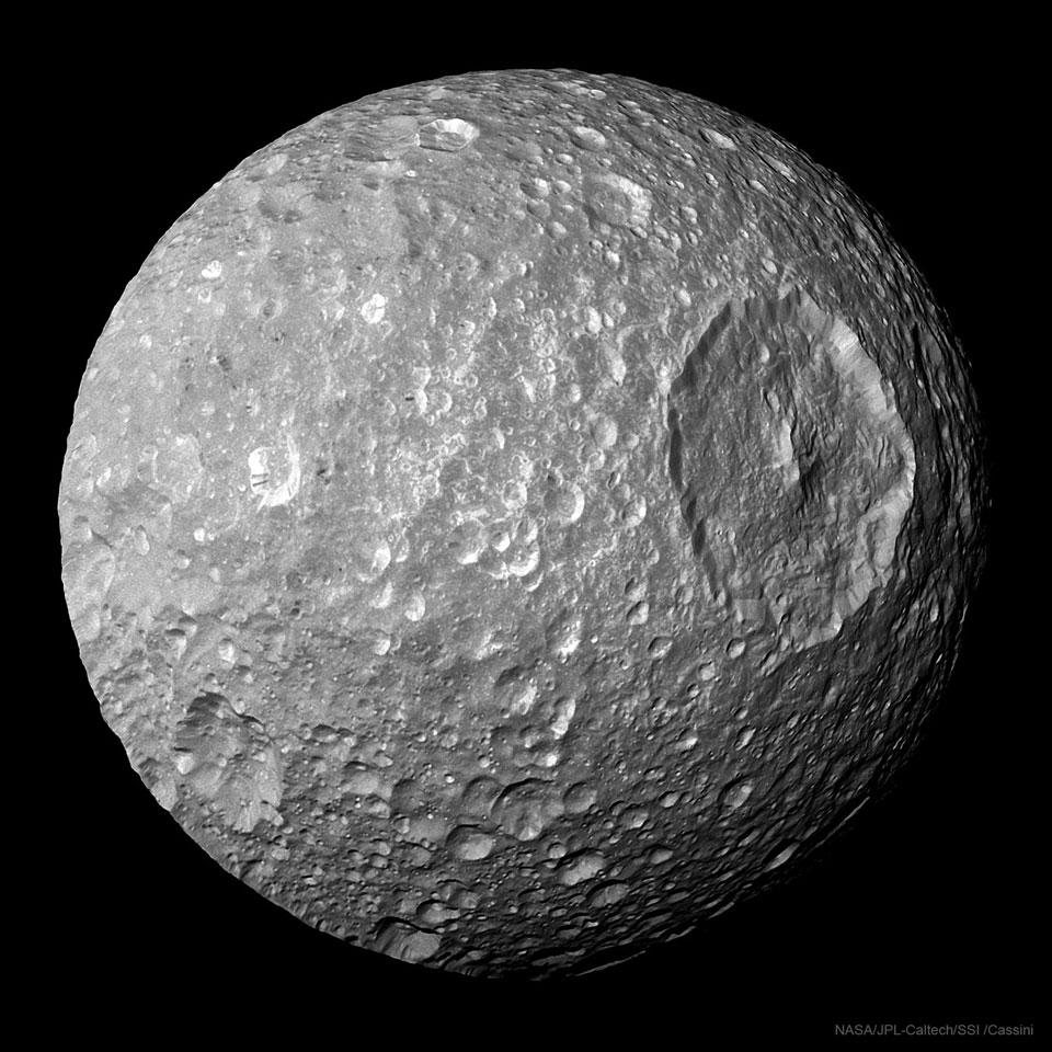 The picture shows Saturn's Moon Mimas featuring a very large circular crater.
Please see the explanation for more detailed information.