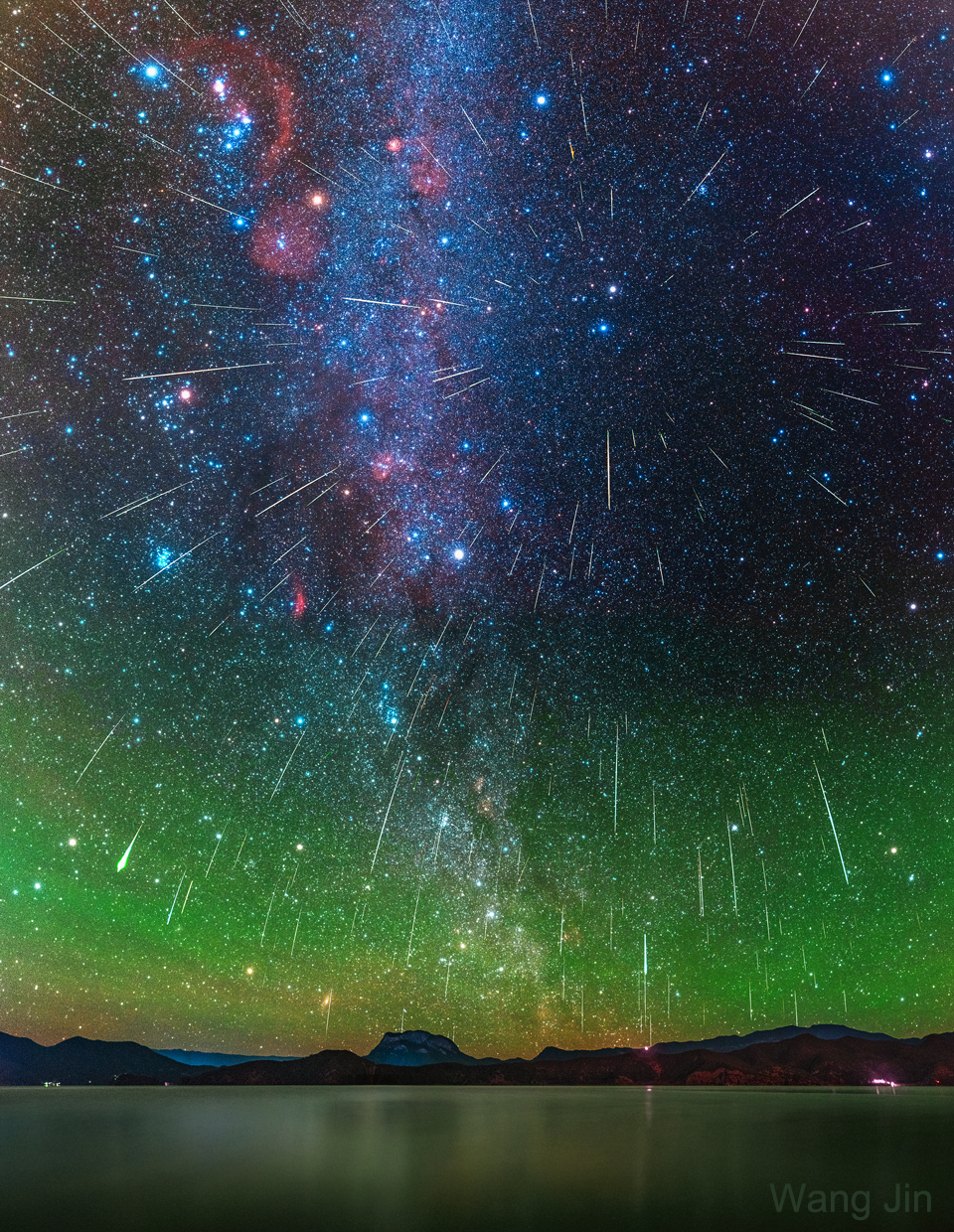 The picture shows a composite of over 200 Geminid meteors
from the 2020 Geminids meteor shower over Lake Lugu in Yunnan, China.
Please see the explanation for more detailed information.