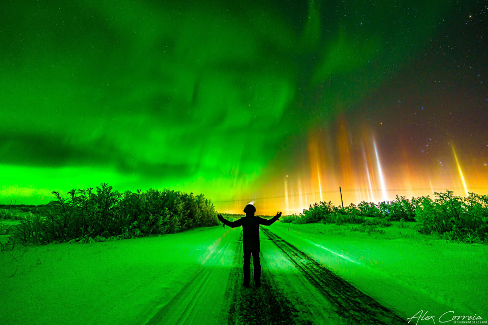The featured image shows the photographer standing
beneath a night sky with green aurora on the left and colorful 
light pillars on the right. 
Please see the explanation for more detailed information.