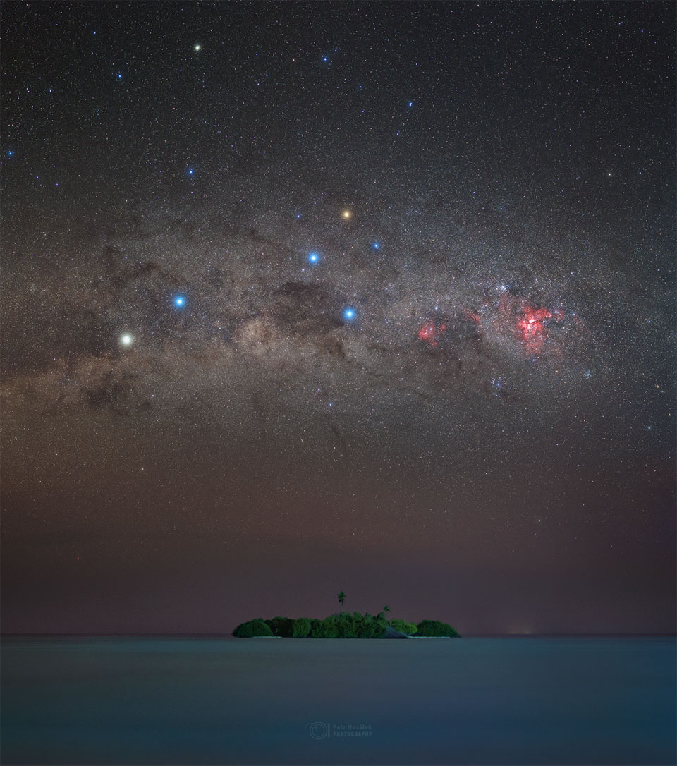 An image of the sky over a small island in the Maldives.
The dark sky contains the Southern Cross and the stars Alpha
Centauri and Hadar. 
Please see the explanation for more detailed information.