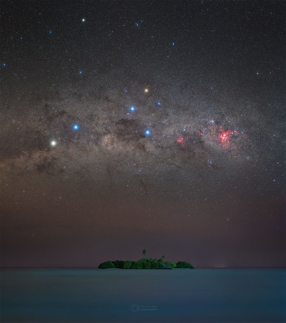 An image of the sky over a small island in the Maldives. The dark sky contains the Southern Cross and the stars Alpha Centauri and Hadar.  Please see the explanation for more detailed information.