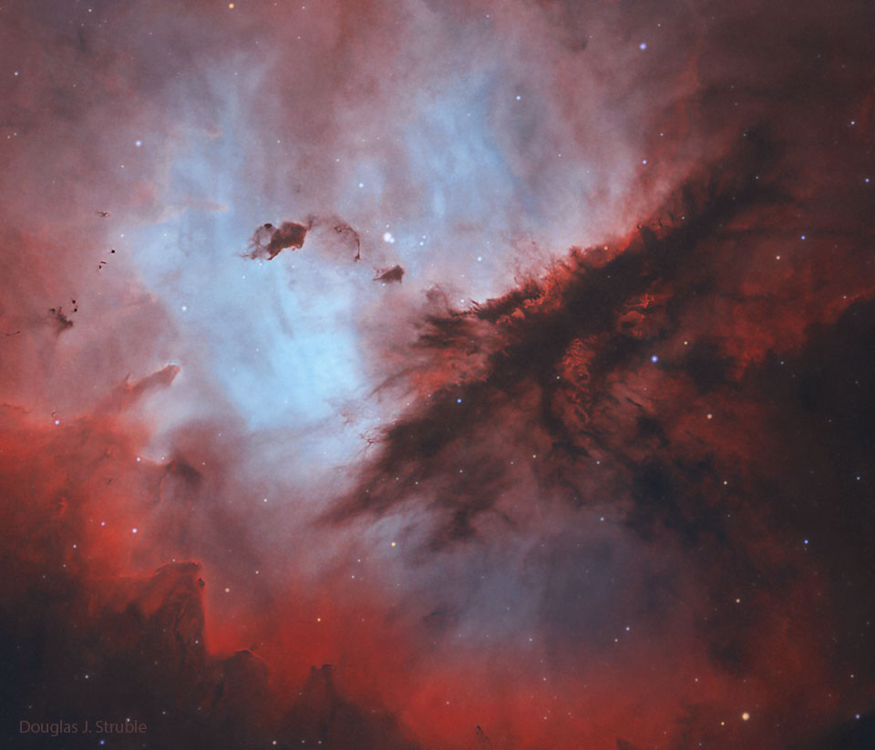 The featured image shows the interstellar dust structures that 
occur on in interior of NGC 281, the Pacman Nebula. The
dark structures are seen against a red glowing background.
Please see the explanation for more detailed information.