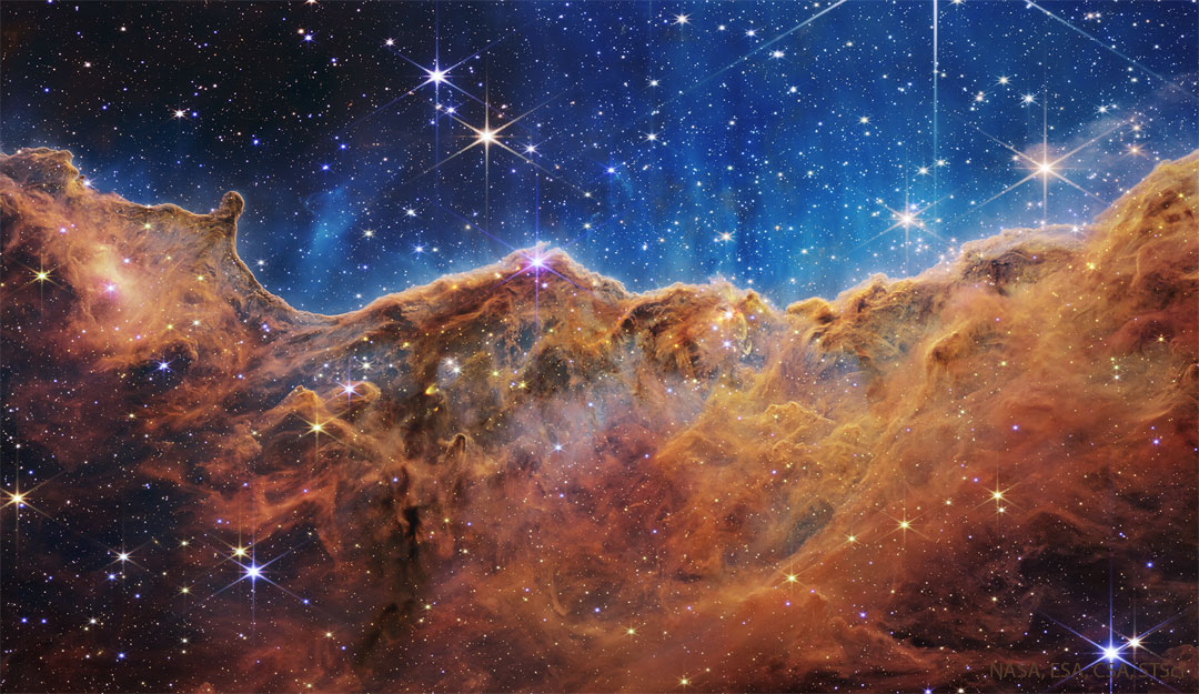 The featured image shows a dense line of dark dust that 
appears like cliffs in the Carina Nebula as captured by the
Webb Space Telescope.
Please see the explanation for more detailed information.