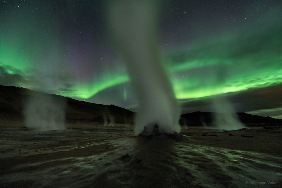 The featured image shows steam rising from several separated
vents at Hverir, a geothermally active field in Iceland. Green
aurora rage in the background. 
Please see the explanation for more detailed information.