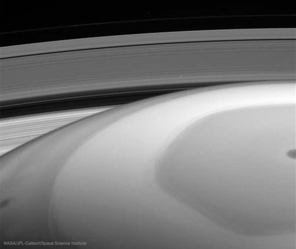 The featured image shows a black and white image with
Saturn's orb dominating the image bottom and Saturn's rings
dominating the image top. 
Please see the explanation for more detailed information.