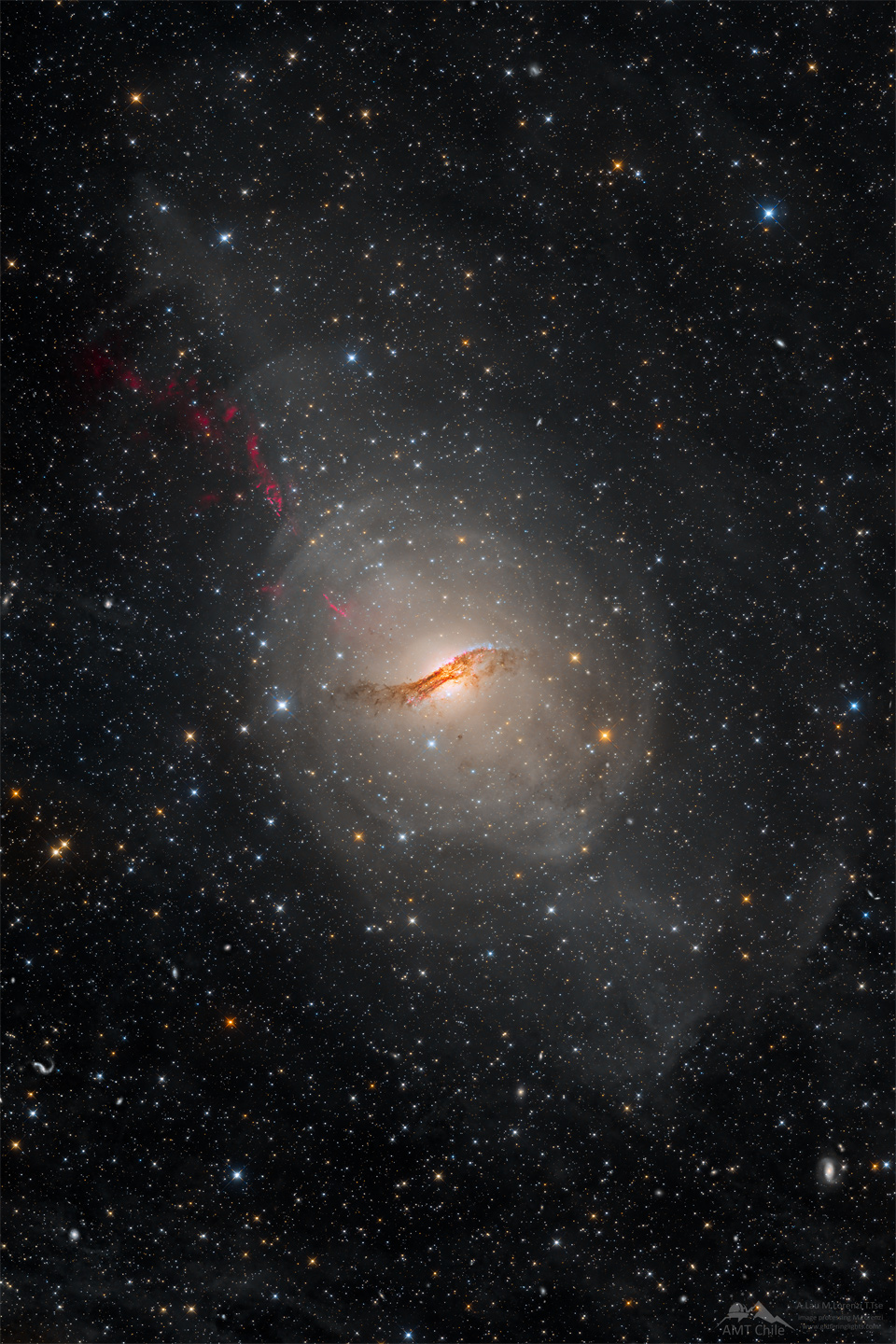 A long duration image of the unusual galaxy Centaurus A.
The galaxy appears as a light oval with a complex dark dust
lane running across its center. A starfield surrounds the galaxy.
Please see the explanation for more detailed information.