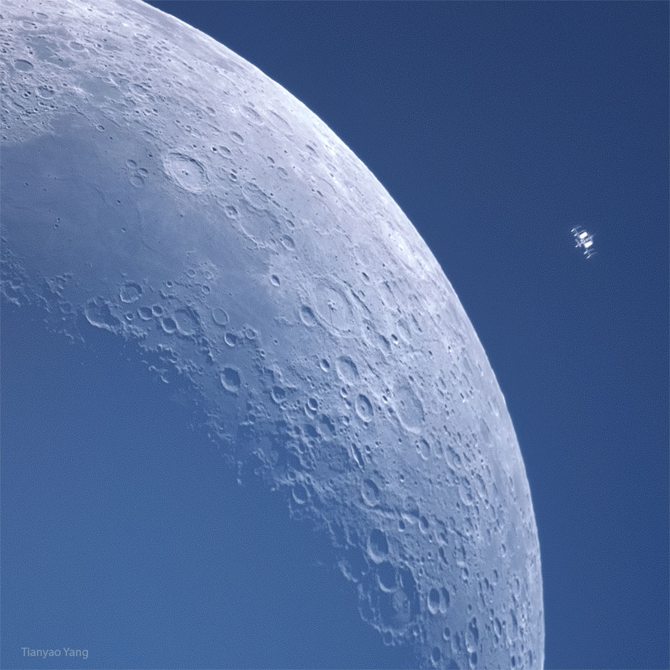 A crescent moon is shown against blue background. Many craters
are visible in great detail. To the upper left appears some kind of
small machine which is actually the International Space Station also
in orbit around the Earth.
Please see the explanation for more detailed information.