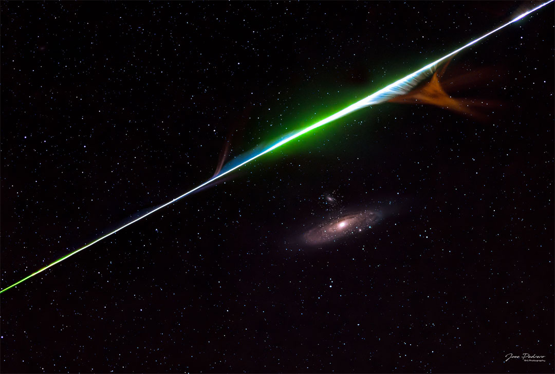 A color meteor streak is seen above the Andromeda spiral galaxy.
Please see the explanation for more detailed information.