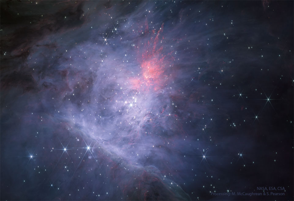 The center of the Orion Nebula is seen in infrared light  as imaged by the James Webb Space Telescope. In the center is  the Trapezium Star Cluster. The main image is in near infrared  light, while the rollover image is in mid-infrared light.  Please see the explanation for more detailed information.