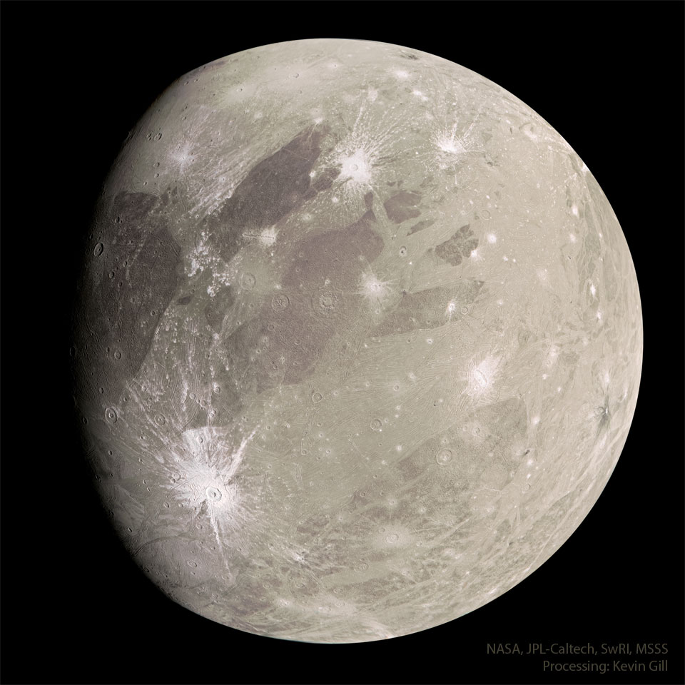 A tan sphere is shown with dark markings and a few light craters.
The sphere is the largest known moon in the Solar System: Jupiter's
moon Ganymede.
Please see the explanation for more detailed information.