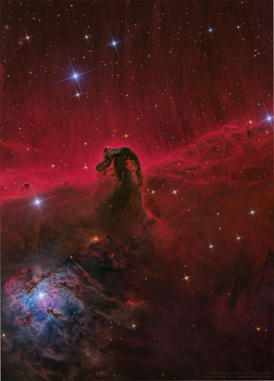 A dark nebula resembling the head of a horse is imaged before a red-glowing background. Stars appear throughout the image. Please see the explanation for more detailed information.