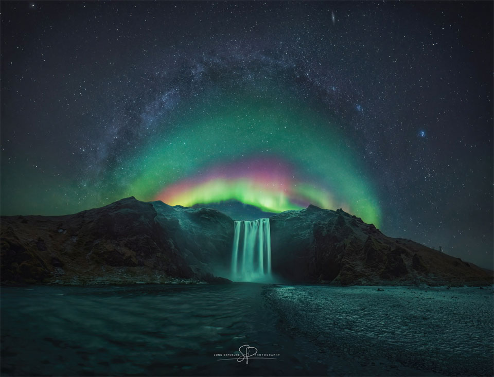Rainbow Aurora over Icelandic Waterfall