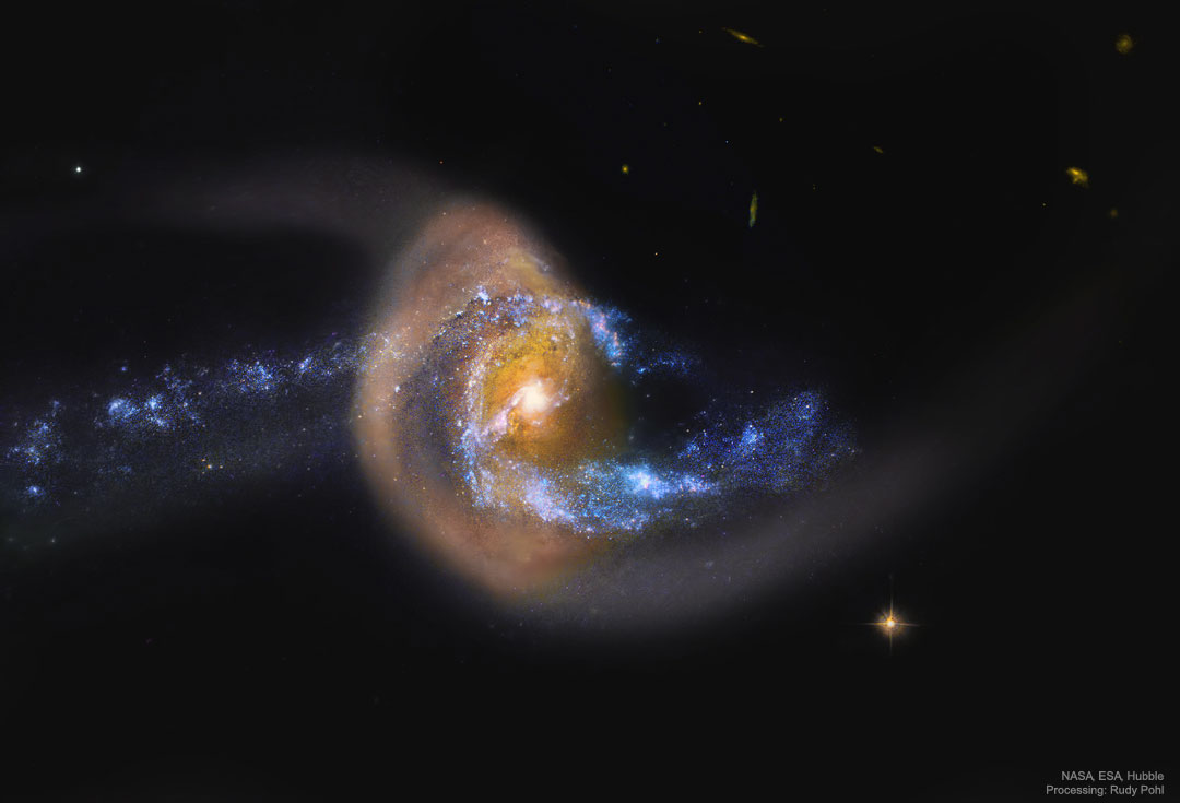 A blue spiral galaxy appears to be colliding -- and possibly
moving through -- a dusty brown galaxy. 
Please see the explanation for more detailed information.