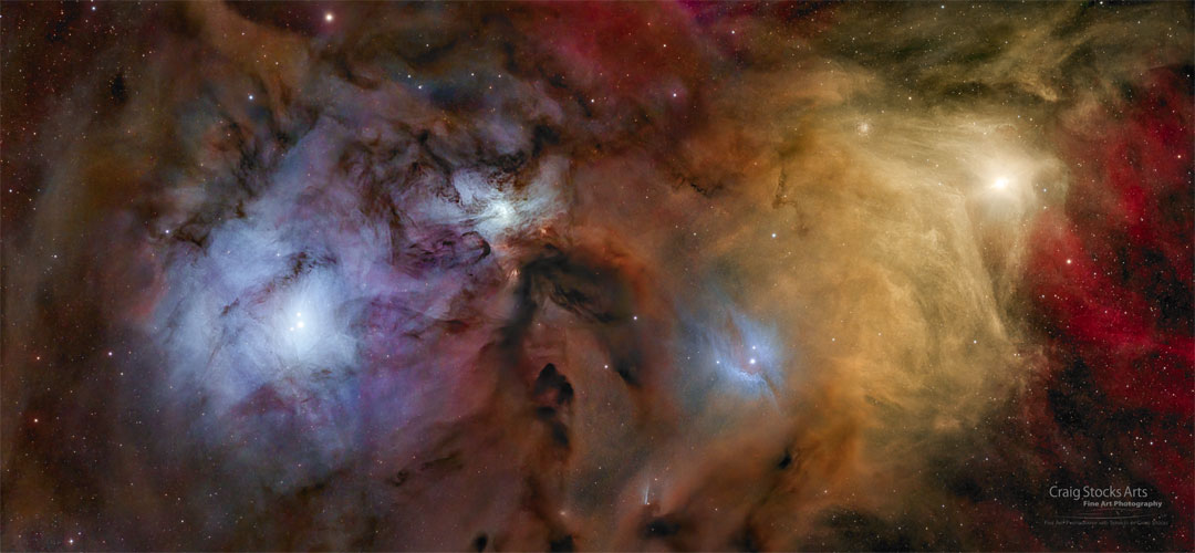 Colorful nebula and stars fill the wide images. The yellow star
Antares is visible on the left and blue reflection nebula surround
a central nebula and the nebula on the right surrounding the Rho
Ophiuchi star system. 
Please see the explanation for more detailed information.