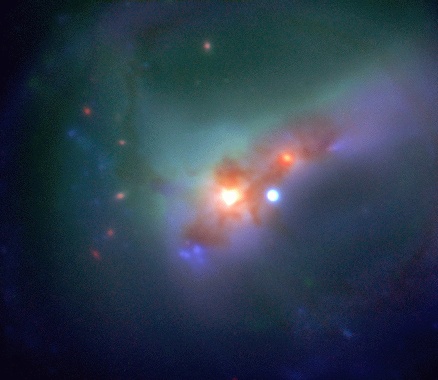 SO202-G23 is a colorful mess.  It is a collision between two galaxies taking place over hundreds of millions of years.  The representative colors give astronomers some idea of what is going on. Visible in this jumble is an  active nucleus spewing ultraviolet radiation which lights up surrounding gas (blue); galactic arms contorted by the gravity of the collision (green); a star forming complex left of center (blue); and dust (red).  In billions of years this mess might settle into a relatively normal looking galaxy.