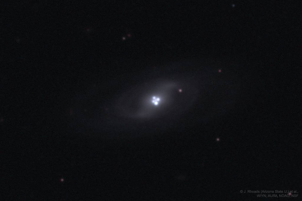 The picture shows single distant quasar that appears
four times due to the gravitational lens effect of an
intervening galaxy.
Please see the explanation for more detailed information.
