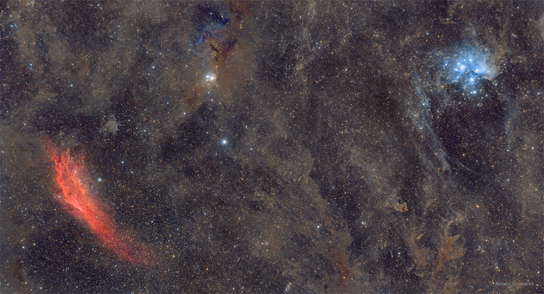The featured image shows a wide field with the 
red California Nebula on the far left, the blue 
Pleiades Star Cluster on the right, and much brown 
interstellar dust in between. 
Please see the explanation for more detailed information.