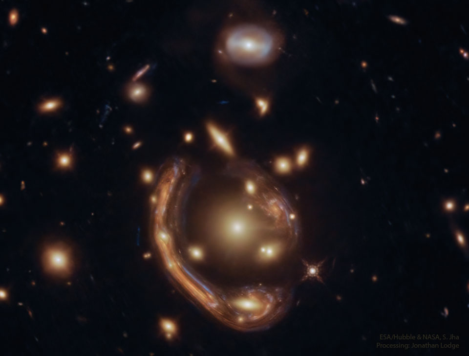 The featured image shows a distant galaxy distorted into 
a giant arc around the center of a galaxy cluster by gravitational
lensing.
Please see the explanation for more detailed information.
