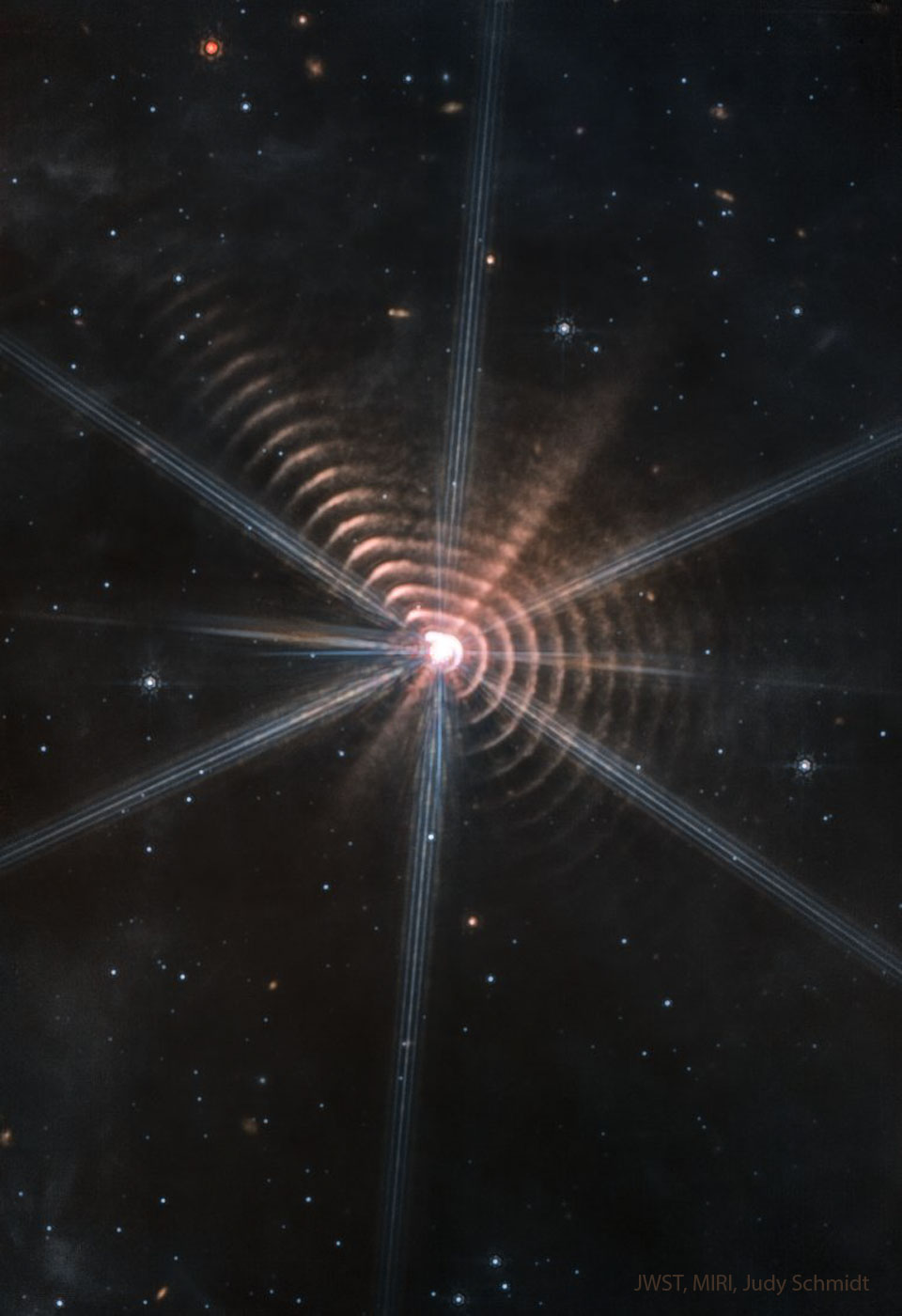 The featured image shows many circular rings 
surrounding a central star. Other stars are visible in
an otherwise dark field.
Please see the explanation for more detailed information.