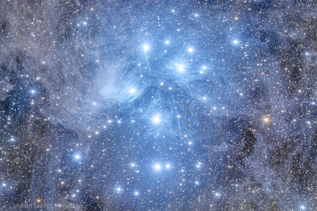 The featured image shows many blue stars clustered 
together in blue-glowing gas and dust.
Please see the explanation for more detailed information.