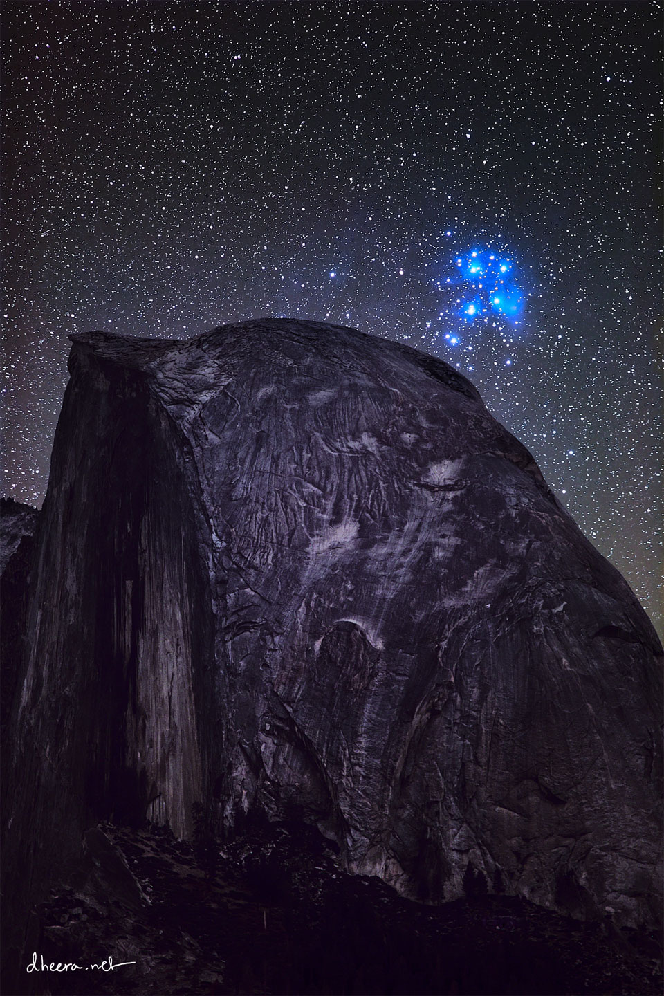 A cluster of bright blue stars is seen on the upper right
while an unusual dome-like mountain occupies most of the 
frame.
Please see the explanation for more detailed information.