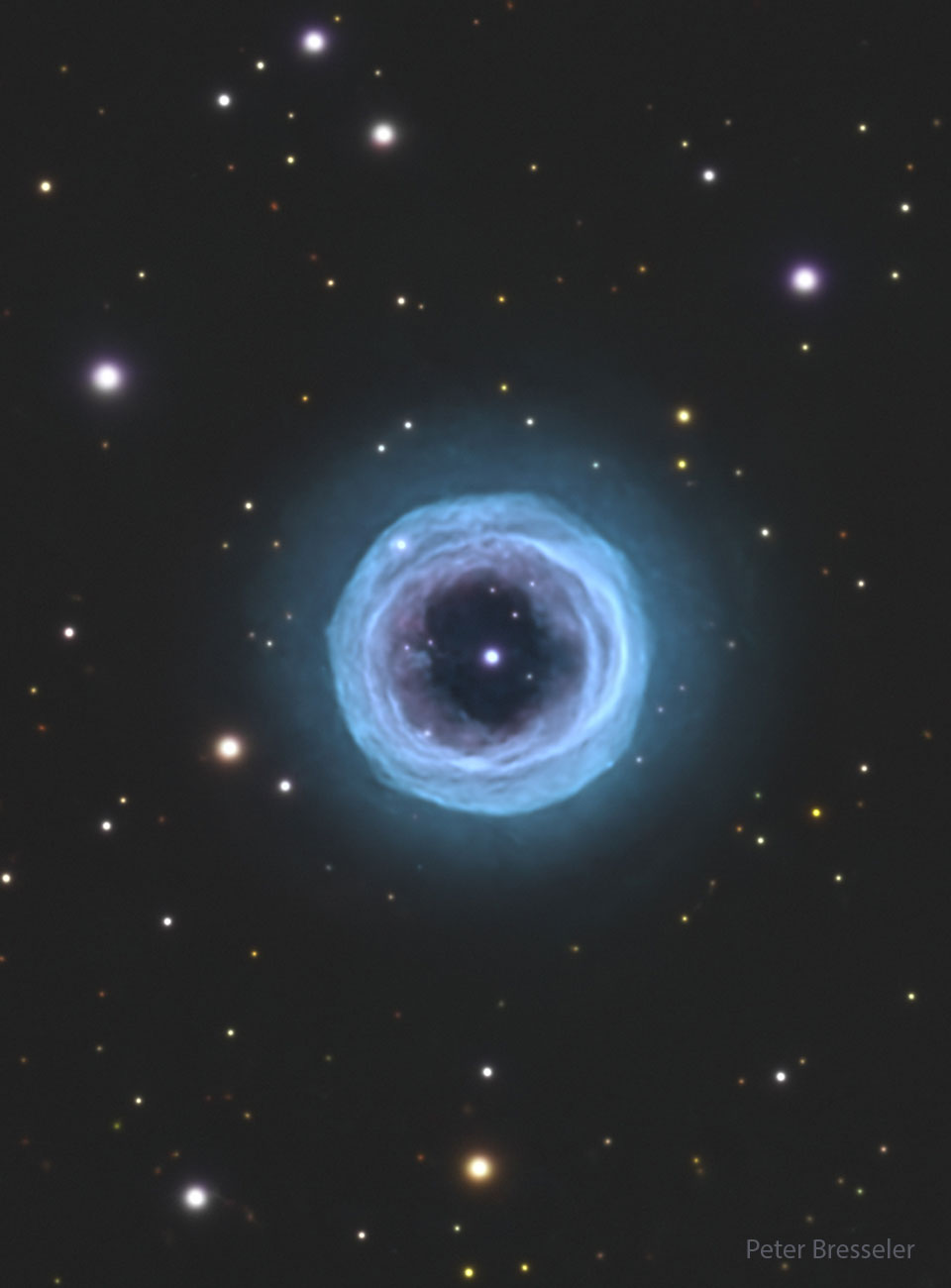 A starfield is shown with a large circular blue
ring in the center. In the ring's center is a bright
blue spot. 
Please see the explanation for more detailed information.